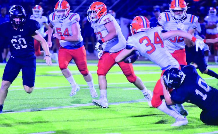Keaton Abshire pulls down a Saints runner as Hayden Garrett moves in to assist. Photo by Randall Luker
