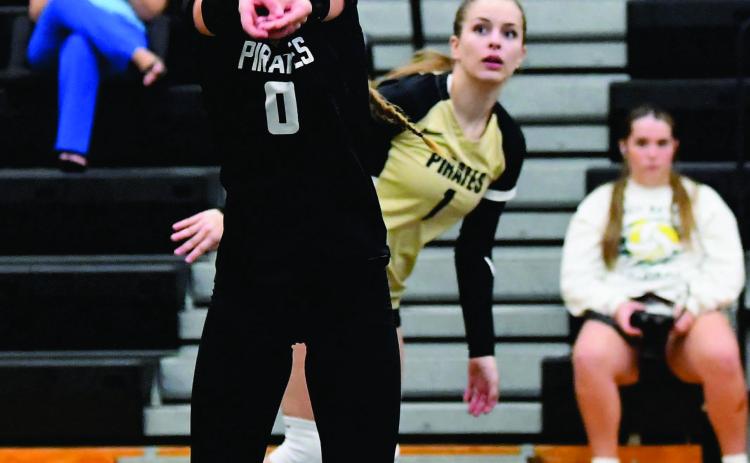 Loghan Matherne sets the ball for Makena Travis in Friday’s home game versus LCM.