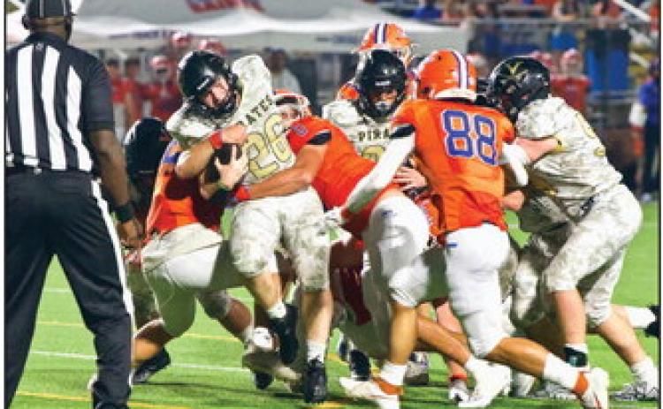 Pirate RB Riley Marlow fights for extra yardage as a pair of Saints defenders try to bring him down. Photo by Randall Luker