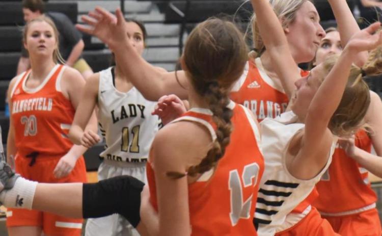 Lady Pirate Mia Robin is upended as she shoots in Tuesdays district game versus Orangefield. Photos by Randall Luker